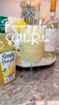 a table topped with glasses and bottles of alcohol