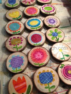 several wooden slices with flowers painted on them