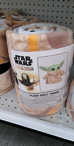 stuffed animals are on display for sale in a toy store, including baby yoda and the child's first star wars costume