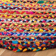 multi colored braided rug on wooden floor