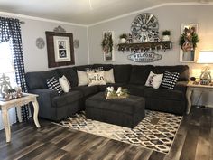 the living room is decorated with black and white decor, including a large sectional couch