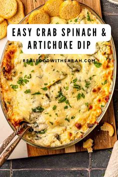 an easy crab spinach and artichoke dip in a pan with crackers on the side