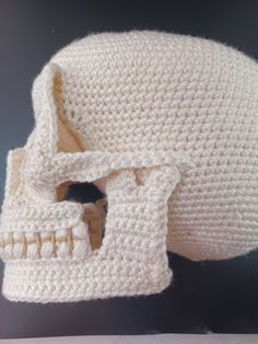 a crocheted white skull with teeth on it