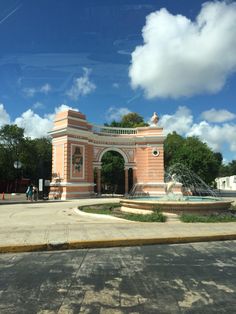 an old building with a fountain in the middle