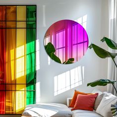 a living room filled with furniture and a rainbow colored wall behind the couch is a round mirror