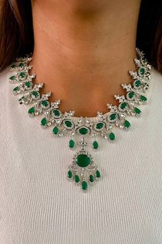 Silver tone floral drop necklace, embellished by clear diamond stones and emerald embellishments. Comes with pair of earrings. - Aza Fashions Emerald Green Jewelry, Emerald Green Stone, Jewellery Sets, Green Jewelry, Drop Necklace, Green Stone, Diamond Stone, Aza Fashion, Online Jewelry