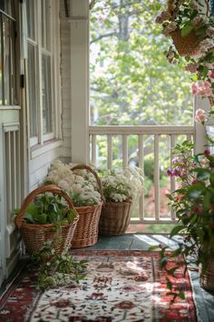 two baskets filled with flowers sitting on top of a porch