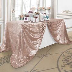 a table with presents on it in front of a mirror and decorated for a wedding