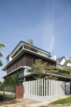 the house is made up of two stories and has a sloping roof that extends from the ground level to the top floor