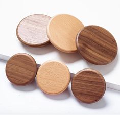 four wooden buttons sitting on top of each other