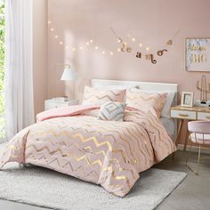 a bedroom with pink walls and white bedding