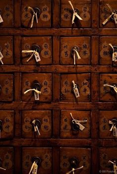 an old wooden drawer with many keys and numbers on it