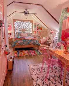 an attic bedroom decorated in pink and turquoise with lots of decorations on the walls, carpeted floor