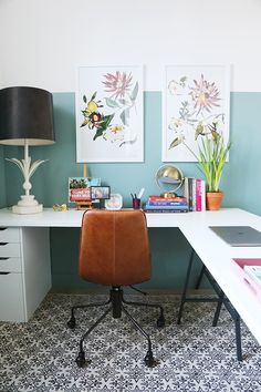 a white desk with a brown chair and pictures on the wall above it in an instagram