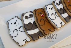 cookies decorated like bears are lined up on a plate