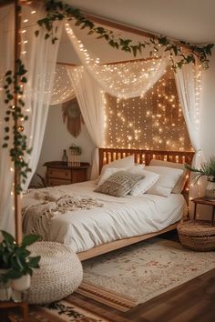 a bed with white sheets and lights on the headboard is surrounded by greenery