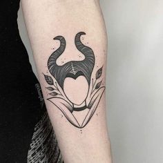 a black and white bull tattoo on the right arm, with an arrow in the center