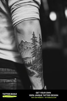 a man with a tattoo on his arm that has trees and mountains in the background