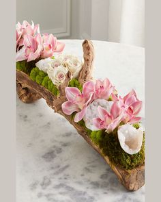 flowers are arranged on a piece of wood