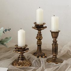 three candles are sitting next to each other on a table