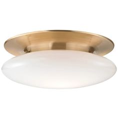 a brass ceiling light with a white glass shade