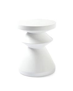 a white table sitting on top of a white floor