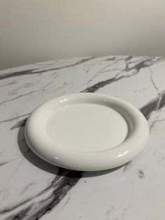 a white plate sitting on top of a marble counter