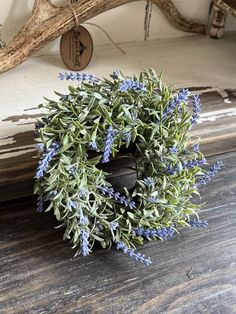 a small wreath is sitting on a wooden table