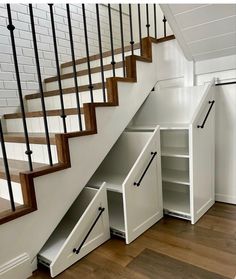 an under the stairs storage unit with drawers underneath and stair railings on either side