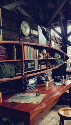 an old fashioned room with bookshelves, desk and clock on the wall in black and white