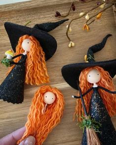 handmade witches with orange hair on wooden table