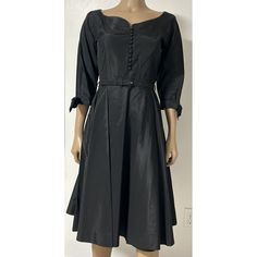 This Stunning Black Taffeta Midi Dress From The 1950s Is A True Vintage Gem. The Dress Features A Tailored Look, With A Flattering Fit For A Size Medium. The Dress Is Perfect For A Cocktail Occasion And Is Sure To Turn Heads. The Taffeta Material Adds A Touch Of Elegance To The Dress. This Original Vintage Piece Is A Plutzer Prize Winner And Is In Excellent Condition. The Dress Has Been Carefully Curated And Is Ready To Be Shown Off. Bring A Touch Of Vintage Glamour To Your Wardrobe With This Amazing Cocktail Dress. Belted With A Slight Iridescent Taffeta. Dress Has A Few Marks, But Overall In Great Condition. Could Use A Careful Steam For Wrinkles. Measurements Approximate Waist 29 Inches Taffeta Dress, Vintage Glamour, Dress Medium, Asymmetrical Dress, True Vintage, Vintage Black, Wrinkles, Steam, Vintage Ladies