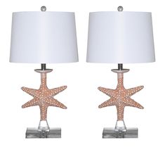 two starfish table lamps with white shades on each lamp and the same light shade