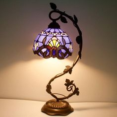 a lamp that is sitting on top of a table next to a white wall and floor