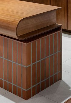 a wooden table sitting on top of a tiled floor