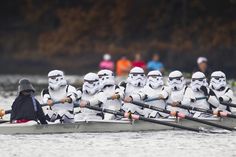 a group of storm troopers rowing in a boat