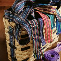 there is a basket that has many different colored ribbons in it