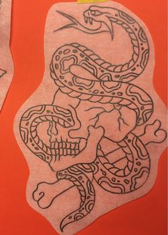 a drawing of a skull with a snake on it's head and another design in the background