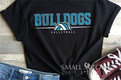 a t - shirt with the words bulldogs volleyball on it next to some shoes and sneakers