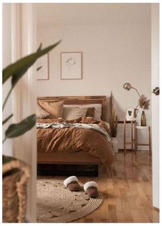 a bedroom with wooden floors and a bed in the corner next to a doorway that leads into another room