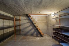 an empty room with shelves and stairs in it