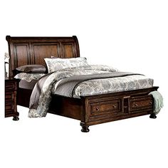 a bed with drawers underneath it and a night stand in front of the headboard