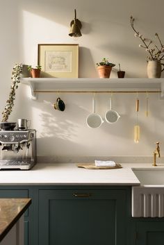 a kitchen with pots and pans hanging on the wall next to a stove top