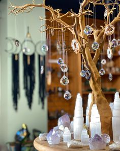 a tree with lots of bubbles hanging from it's branches in front of a mirror