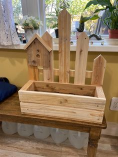 a bench made out of wood with bird houses on it's back and windowsill in the background