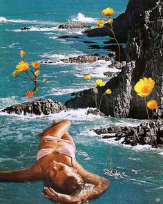 a woman floating in the ocean with yellow flowers