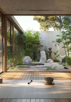 a room that has some plants and rocks on the ground in front of it with glass doors