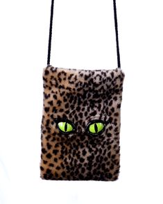 The Furry Leopard green Eyed Kitty Pet me Purse from Zagone Studios is a fashionable and functional accessory for cat lovers. Its plush exterior and roomy interior make it suitable for daily use or formal events. Made with high-quality faux fur, this purse is lightweight yet durable, making it the perfect complement to any outfit. The classic Leopard print adds an element of versatility and sophistication. Whether you're going to a party or just running errands, this women's handbag is the ideal choice for elevating your wardrobe with practicality and fashion. Green Cat Eyes, Thrift Manifest, Head Sock, Trick Or Treat Studios, Cat Purse, Green Cat, Uv Black Light, Larp Costume, Hand Gloves