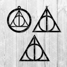 harry potter's triangle and deathly hall ornament on a white wooden background