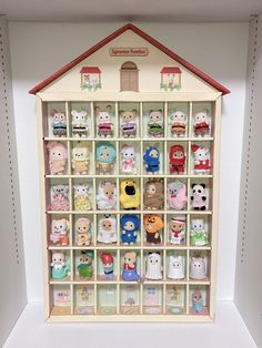 a display case filled with lots of small stuffed animals in it's sides and doors